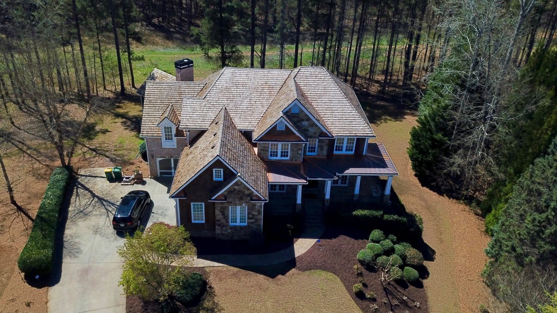 Home with a new architectural shingle roof installed by Total Choice Roofing near Suwanee, GA